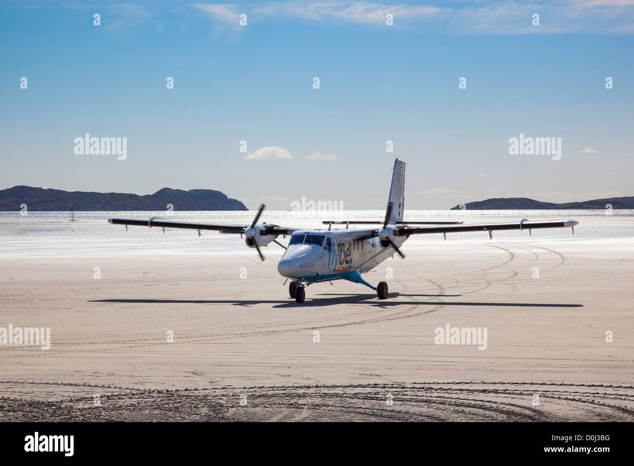 View of an aircraft taxiing across the beach after landing at Barra Airport. Stock Photo