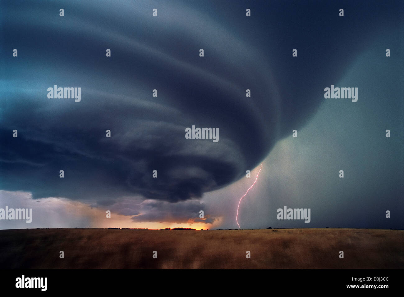 Cloud To Ground Lightning During a Sunset Supercell Thunderstorm Stock