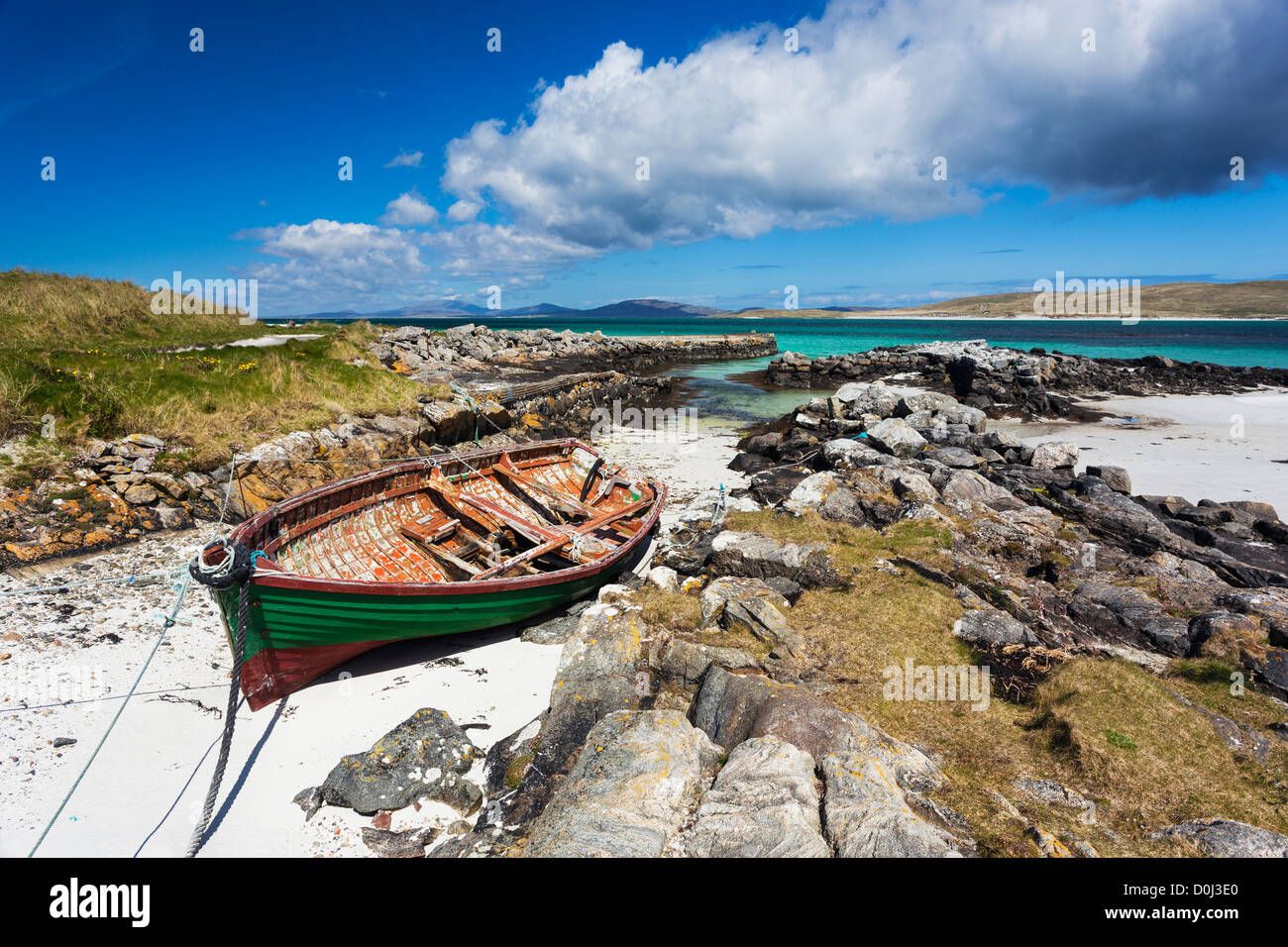 A view of a boat moored in an inlet at Eoligarry Pier. Stock Photo