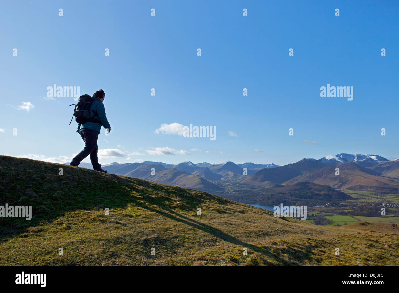 Away From Ridge Walker descending a ridge with hills in the background Stock Photo - Alamy