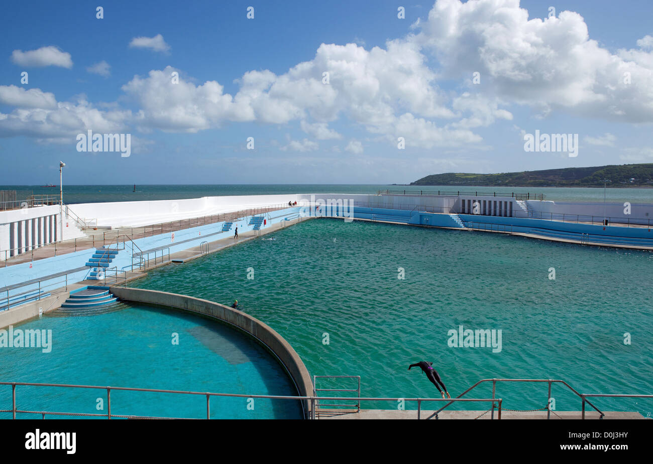 Swimmer diving into the Jubilee Pool in Penzance. Stock Photo