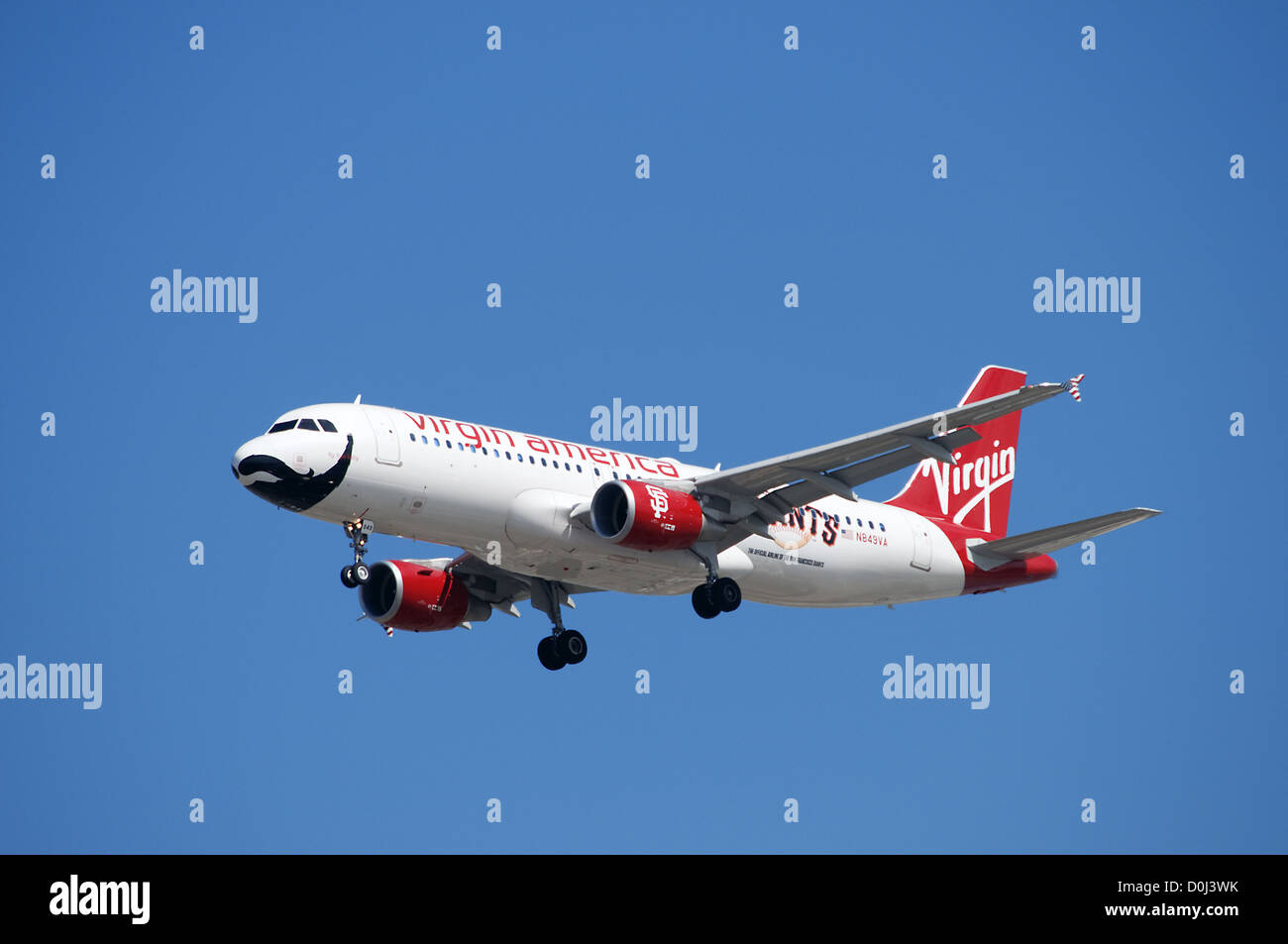 Virgin America jet airplane featuring San Francisco Giants baseball team is landing at LAX Stock Photo