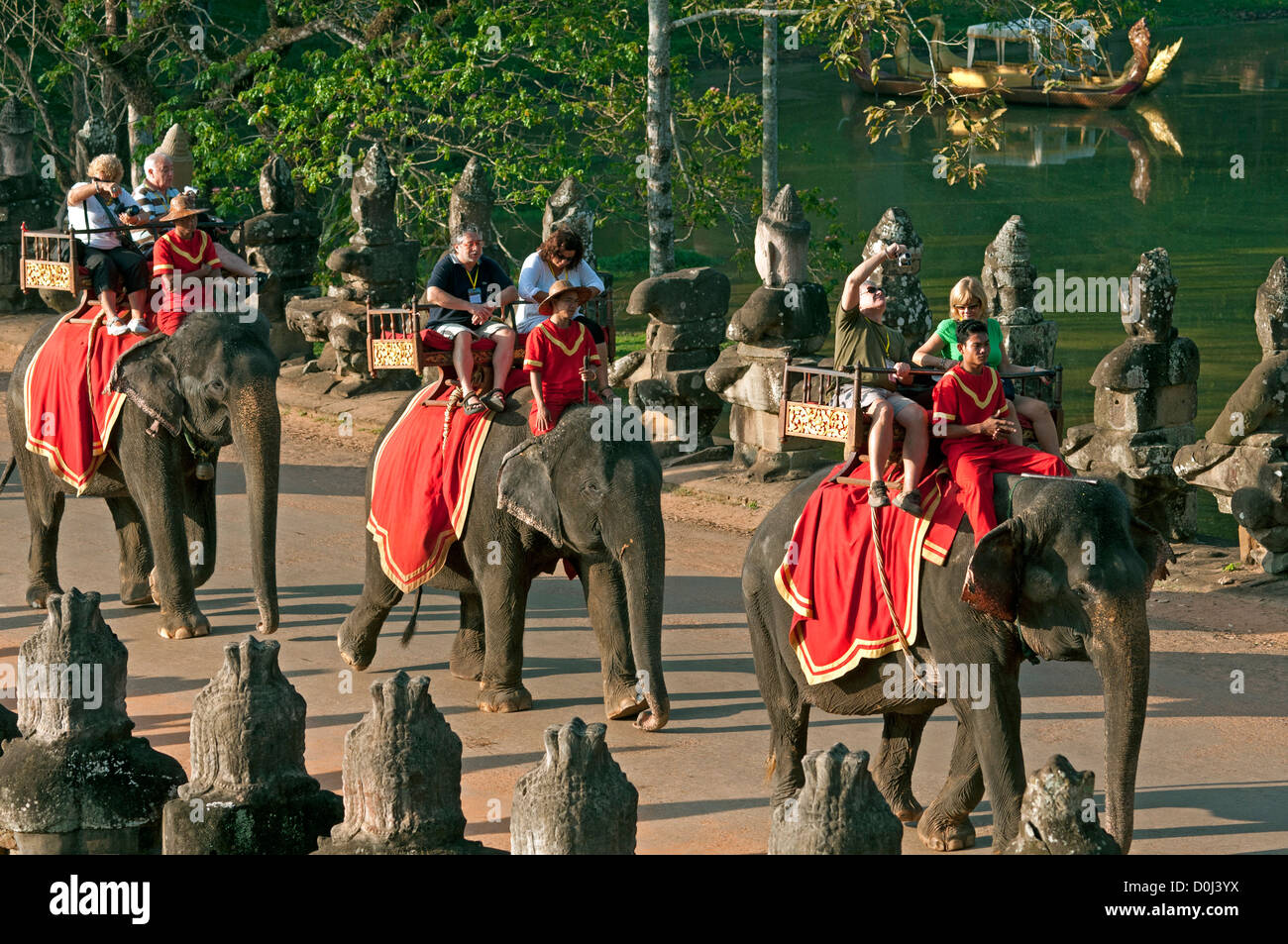 Tourists on elephants near the South Gate on a visit to Angkor Thom, Angkor, Cambodia Stock Photo