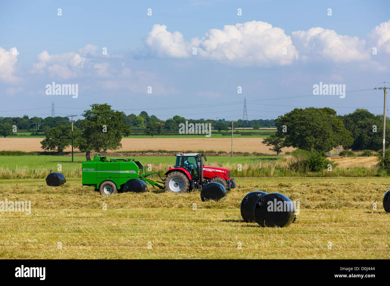 Tractor in field making hay bales Stock Photo Alamy