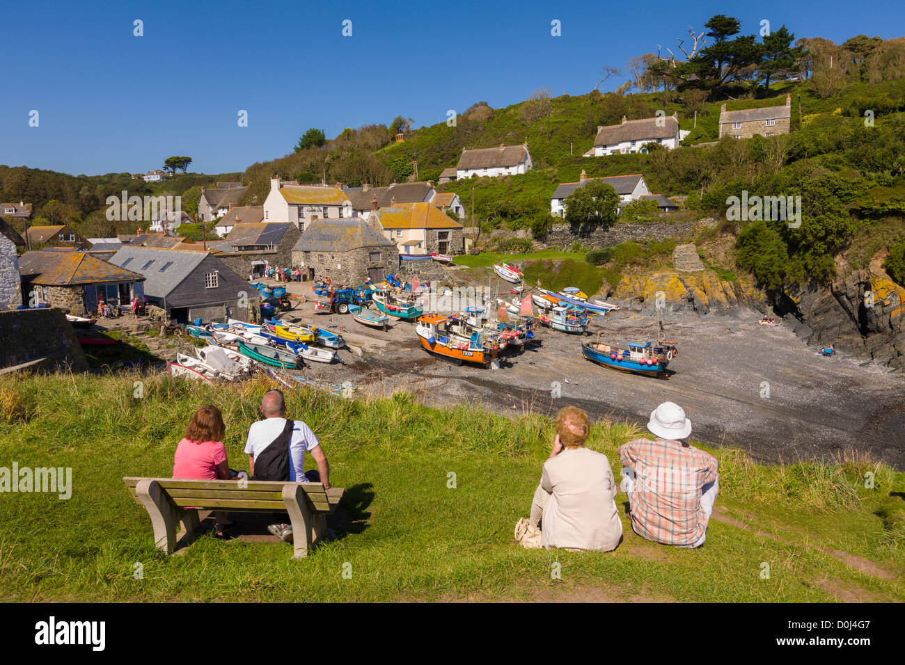 Tourists looking at Cadgwith harbour, Cornwall, England Stock Photo