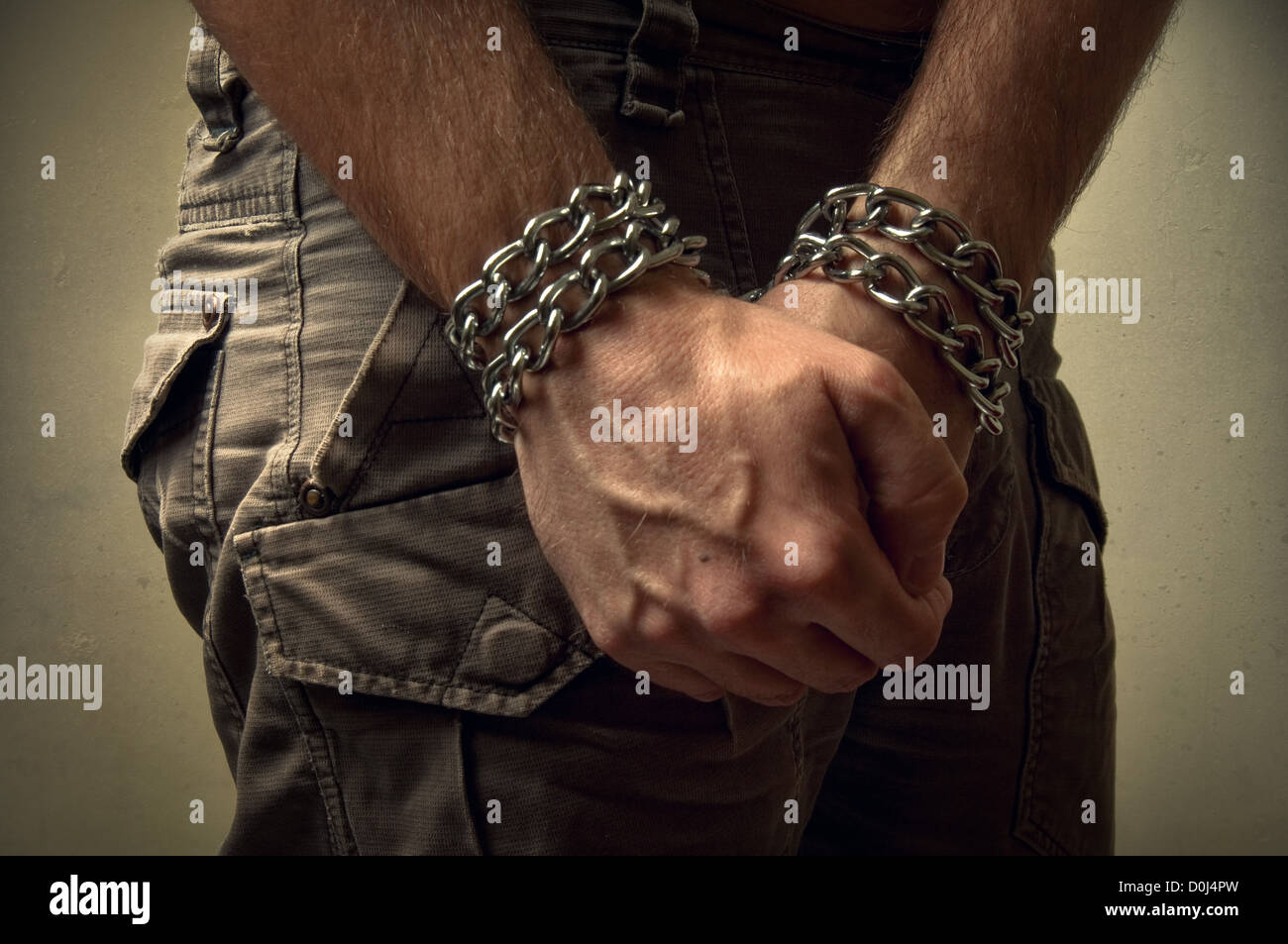 Male hands with chain wrapped around them, prisoner concept Stock Photo