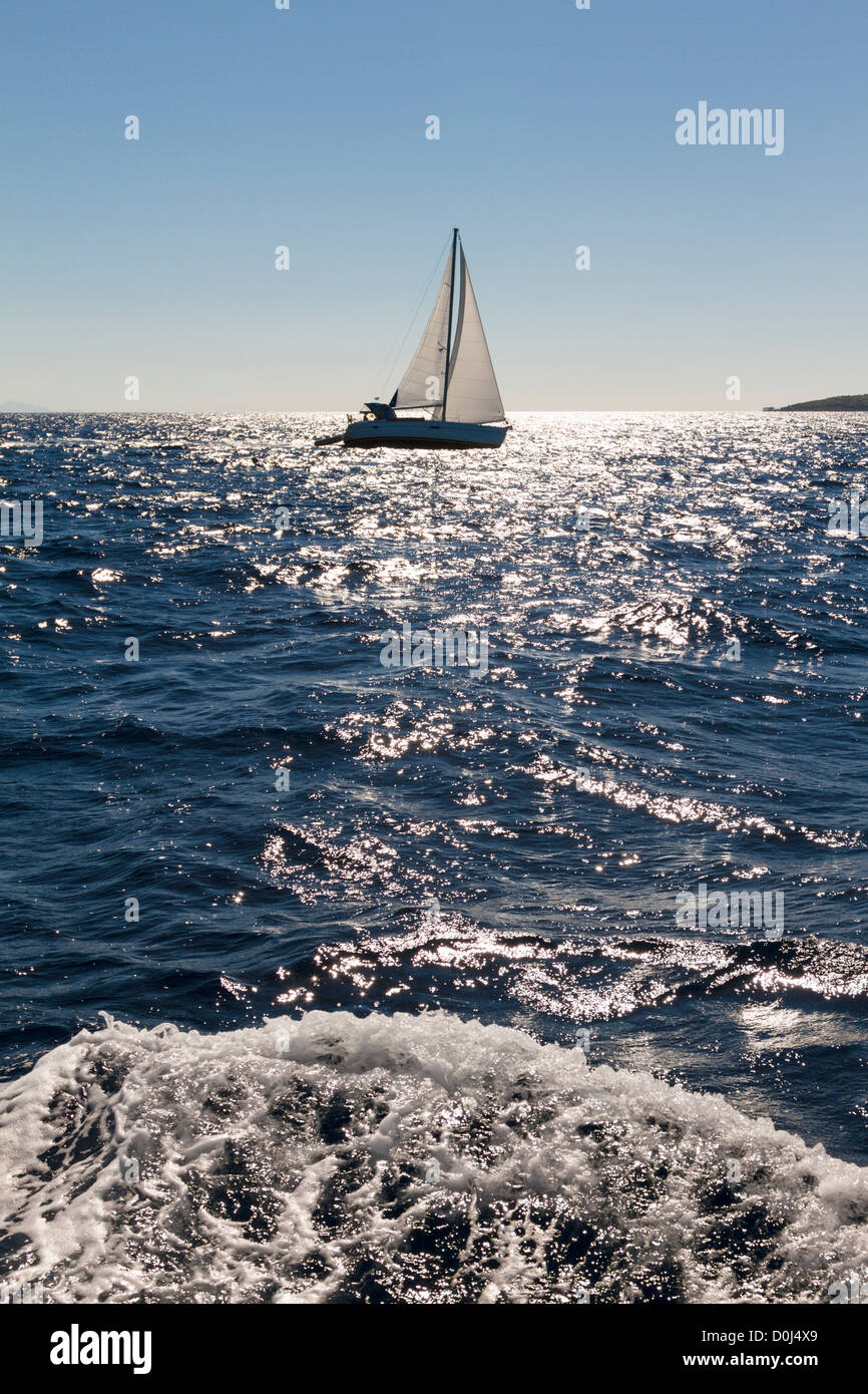 Yacht sailing in blue water Stock Photo - Alamy