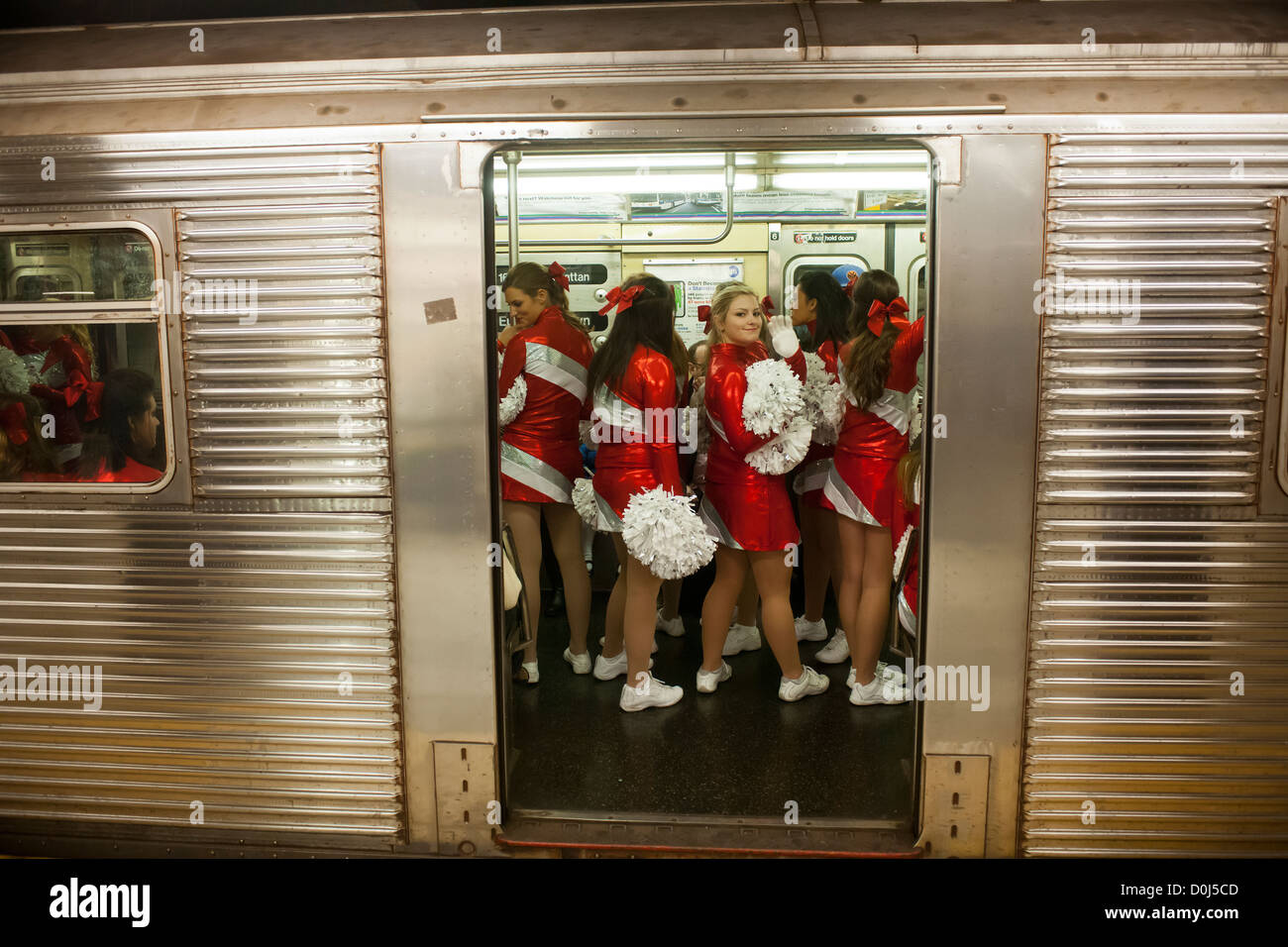 Members of the Varsity Spirit cheerleading team, travel via the subway