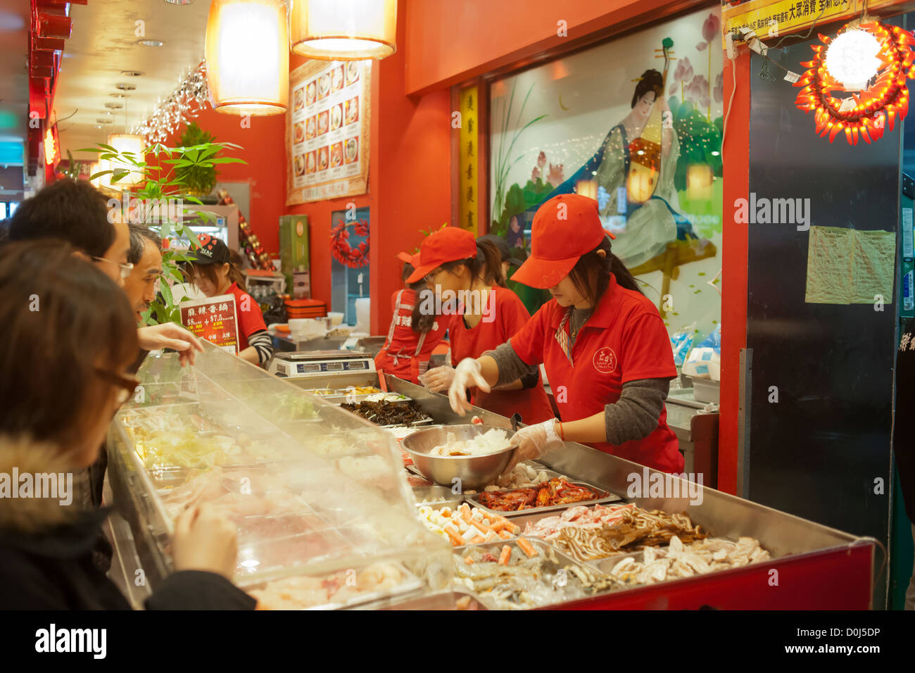 Counter workers prepare ingredients for Mongolian Hot Pots in the busy food court of the New