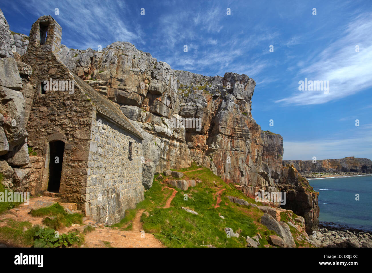 14th century St Govan's Chapel built into the cliffs overlooking St Govan's Head. Stock Photo