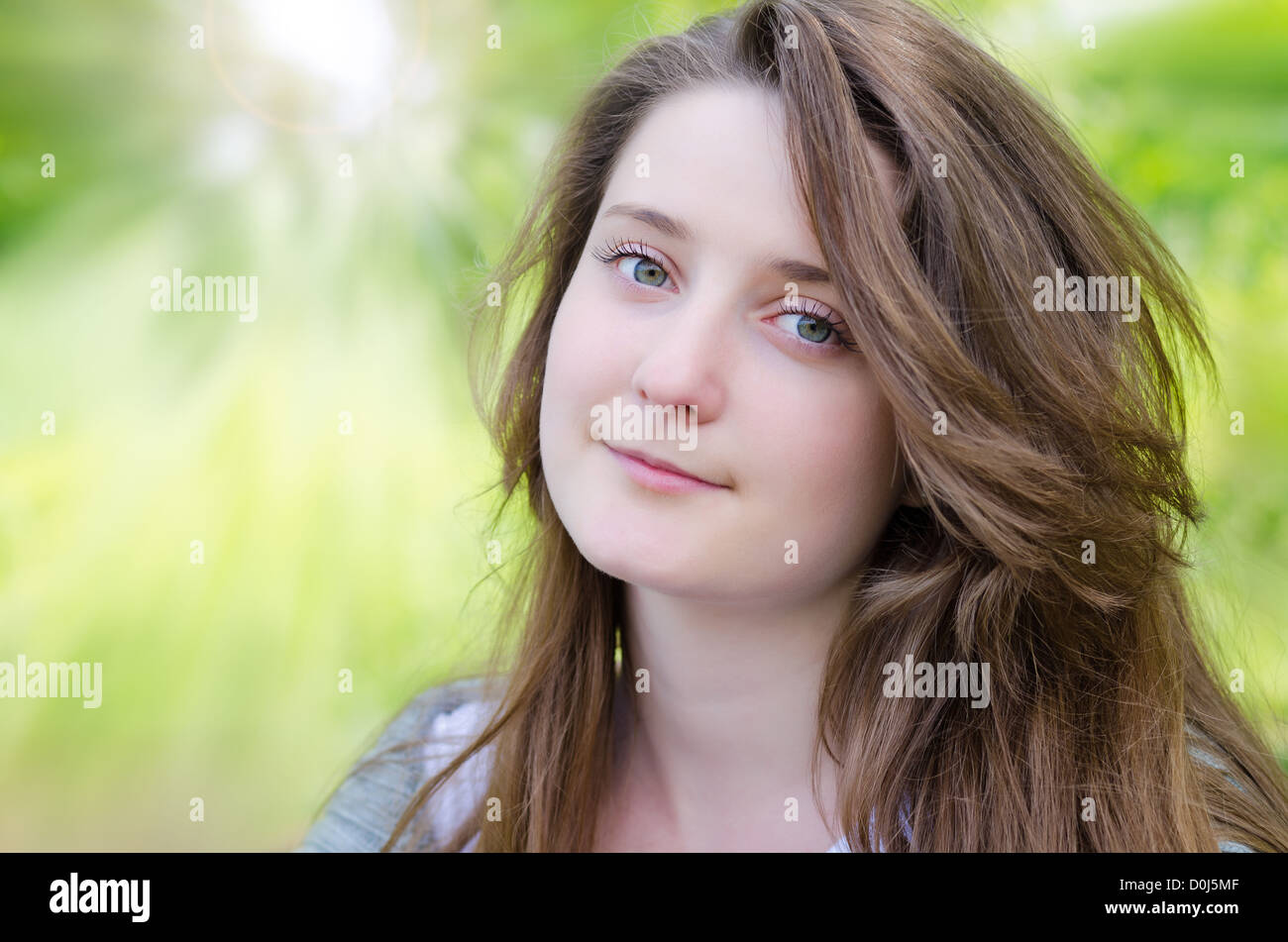 Portrait of attractive young woman in park under natural light Stock Photo