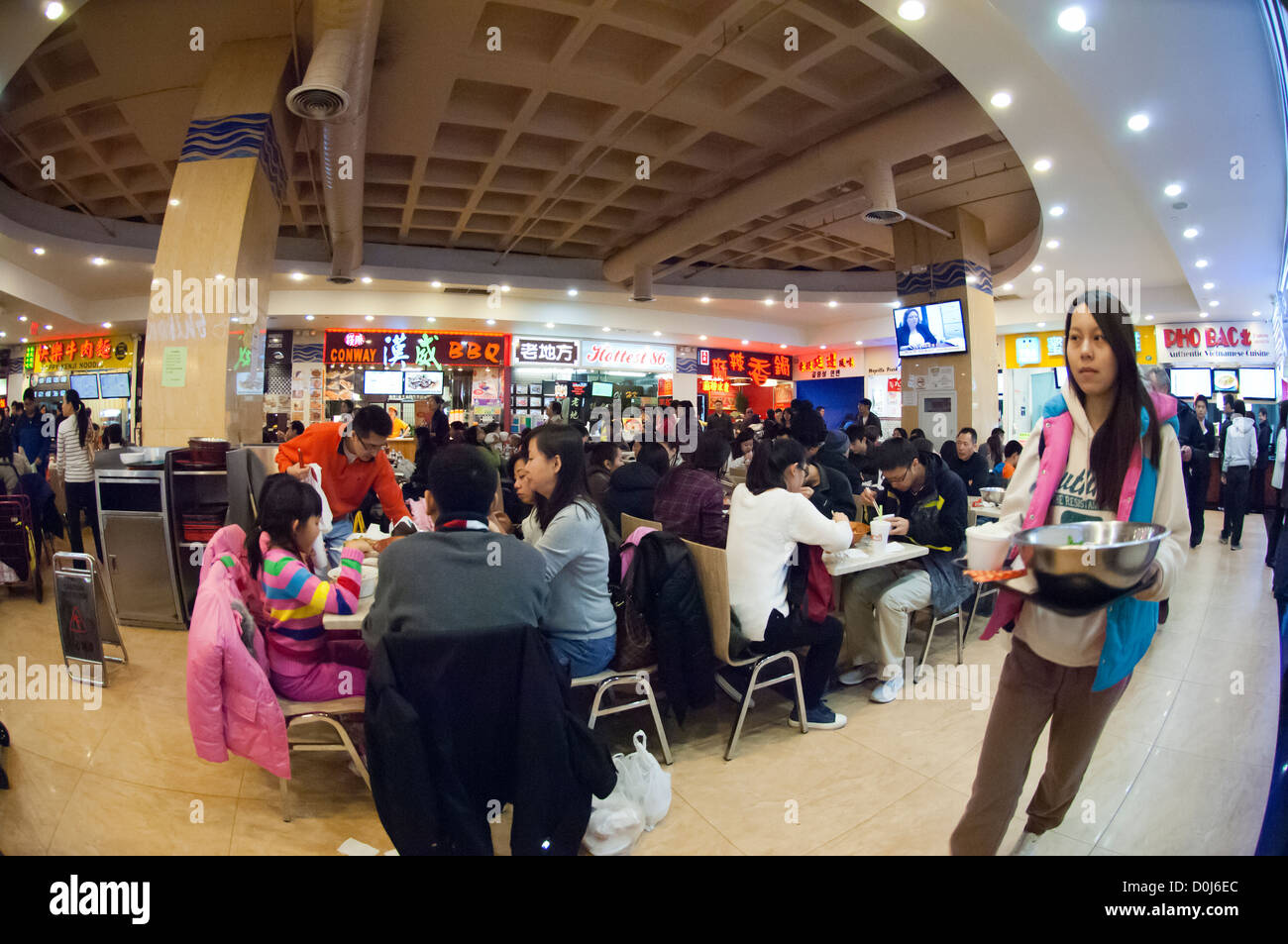 People in the food court of the New World Mall in the Chinese neighborhood of Flushing, Queens in New York Stock Photo