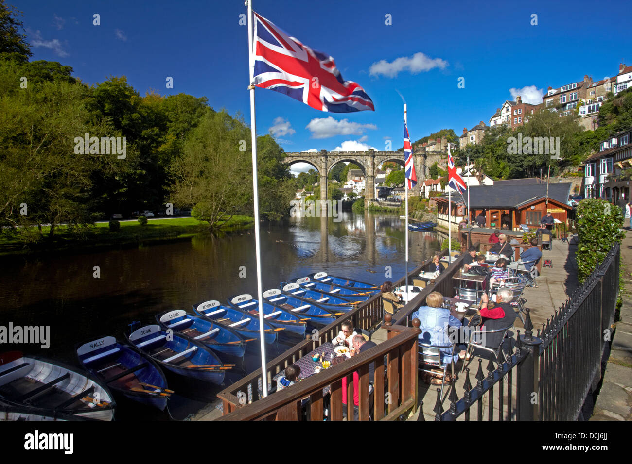 A view of the River Nidd from the riverside cafe with the Victorian railway viaduct reflected in the waters below. Stock Photo