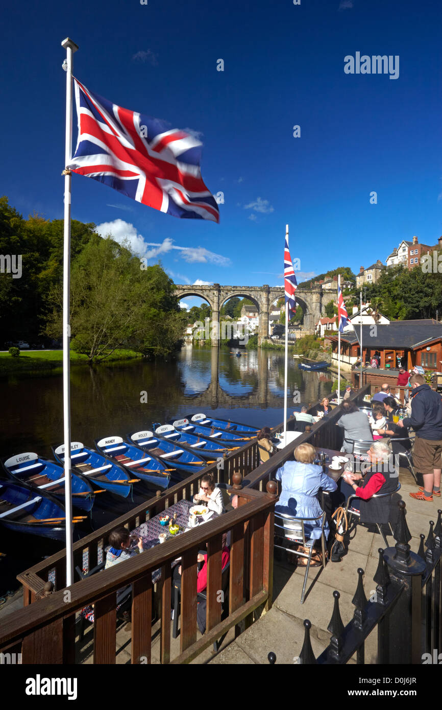 A view of the River Nidd from the riverside cafe with the Victorian railway viaduct reflected in the waters below. Stock Photo