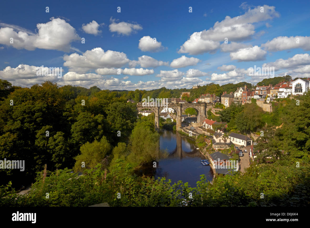 A view of Knaresborough and  the River Nidd showing the Victorian railway viaduct reflected in the waters below. Stock Photo