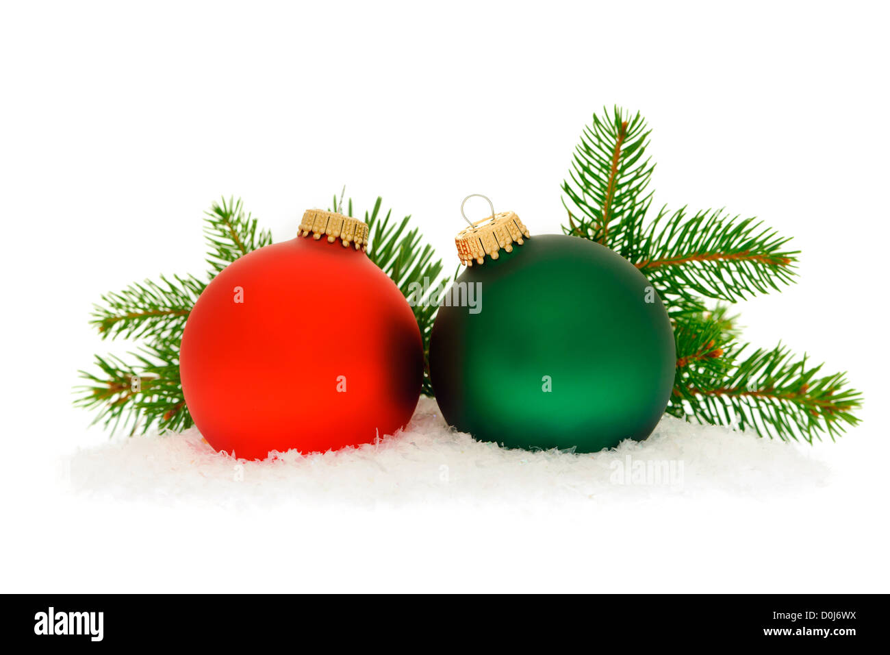 Red and green christmas balls with spruce tree branch isolated on white background Stock Photo