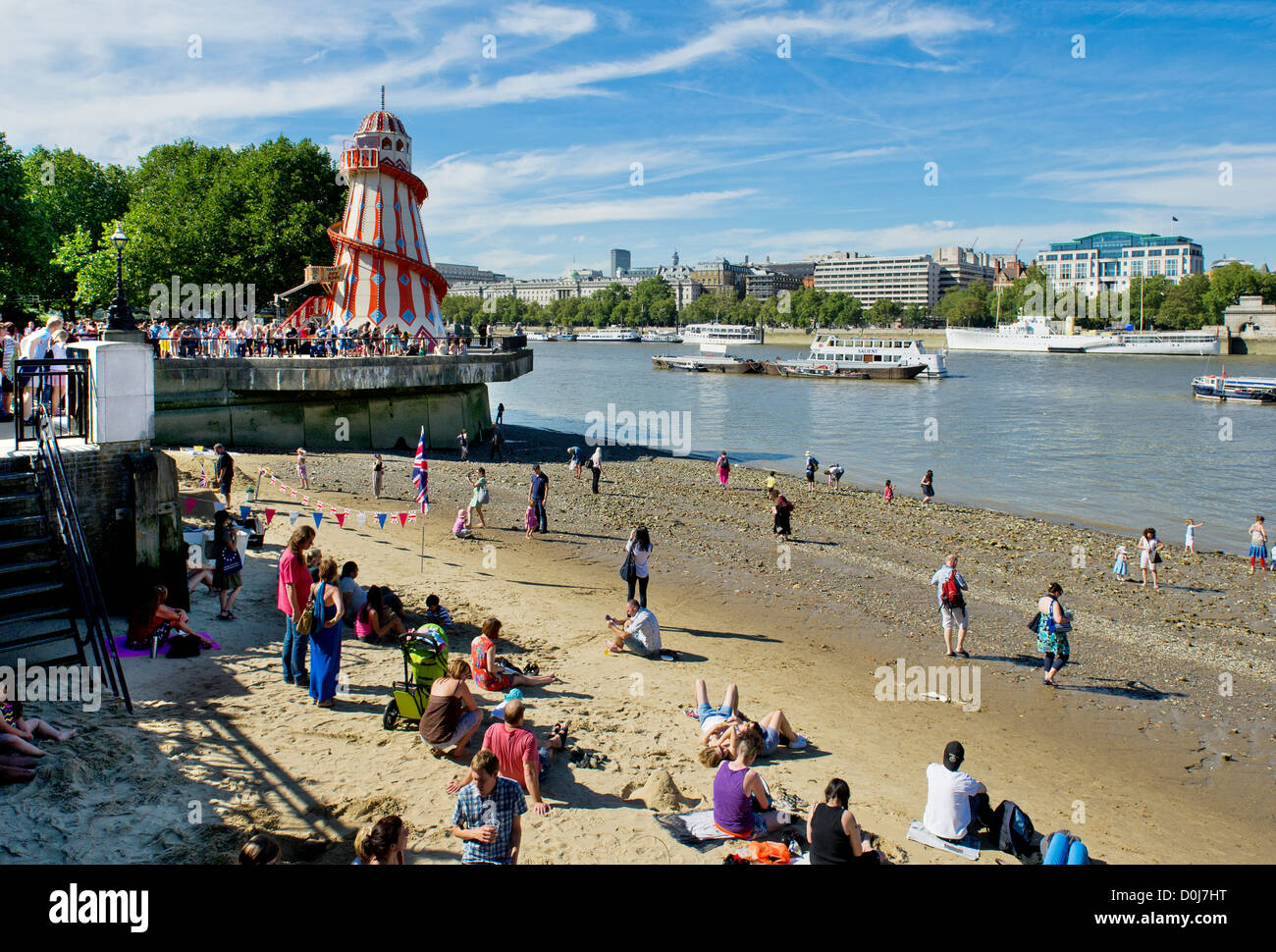 People enjoying themselves on the foreshore of the River Thames. Stock Photo