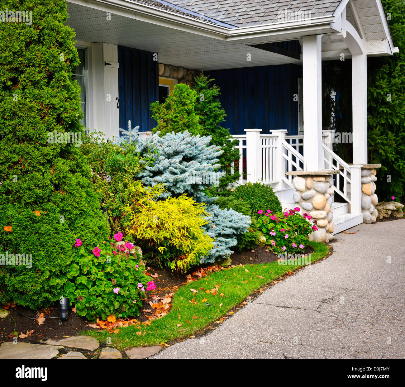 Front entrance of house with garden and porch Stock Photo