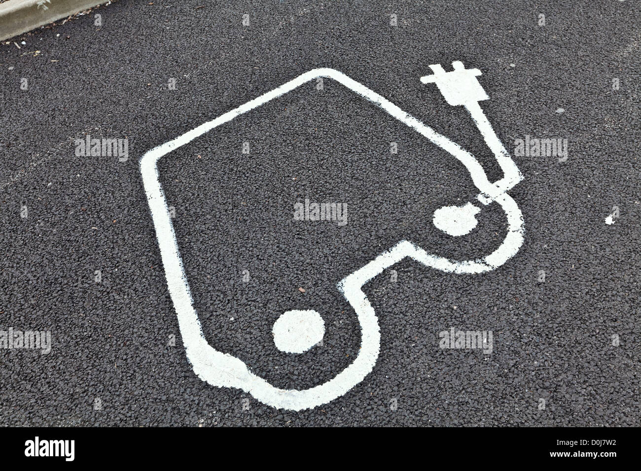 Painted road sign indicating electric car recharging point. Stock Photo