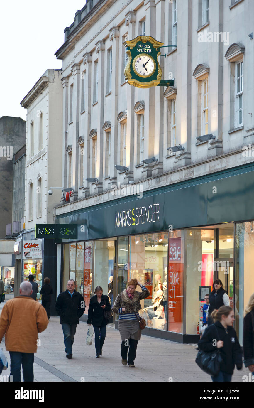 Shoppers passing by a Marks & Spencer department store in Cheltenham