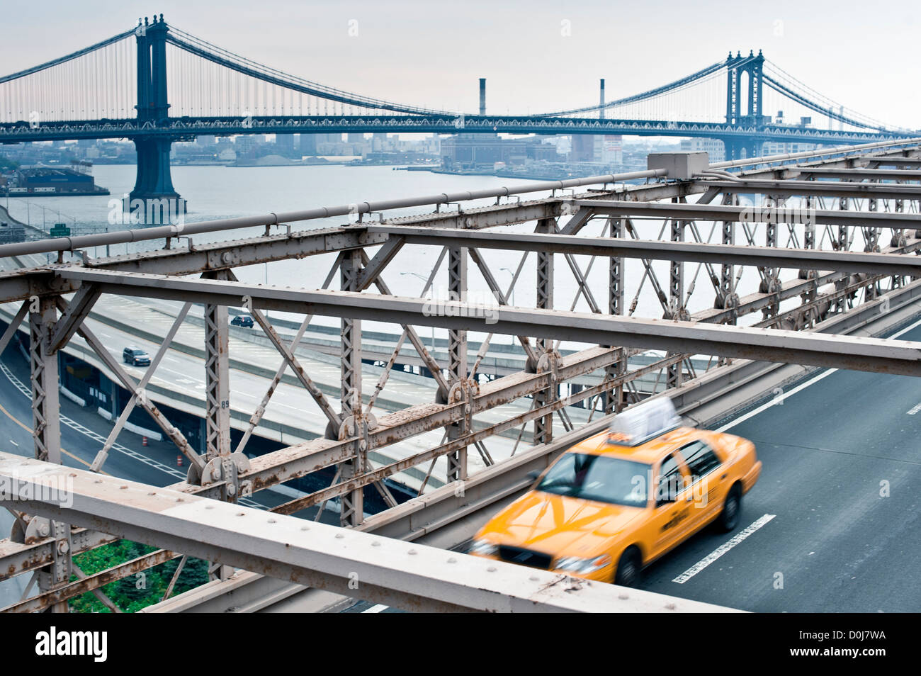 New York taxi speeds along on the Brooklyn Bridge, New York Stock Photo