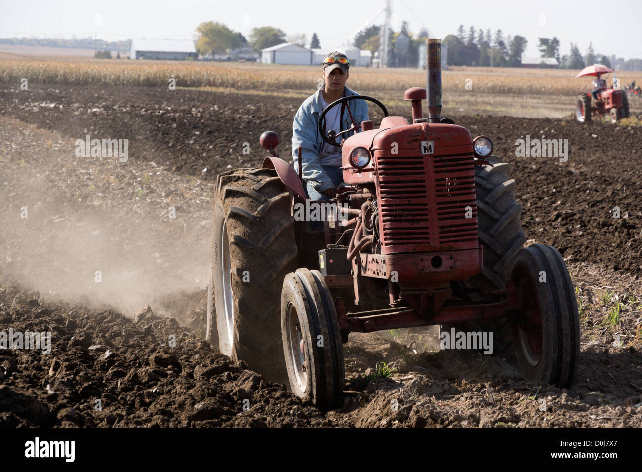 Antique Farmall tractors in a plowing demonstration on a farm near Hebron, Illinois. Stock Photo