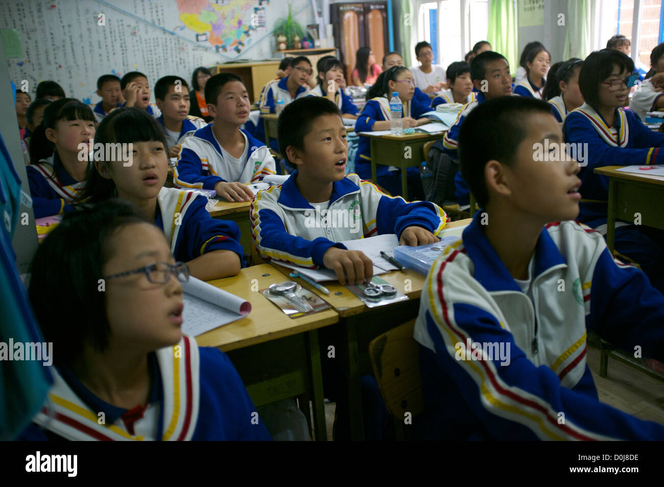 Chinese students attend a lesson in a classroom at a  middle school for migrant workers on the outskirts of Beijing, China. 2012 Stock Photo