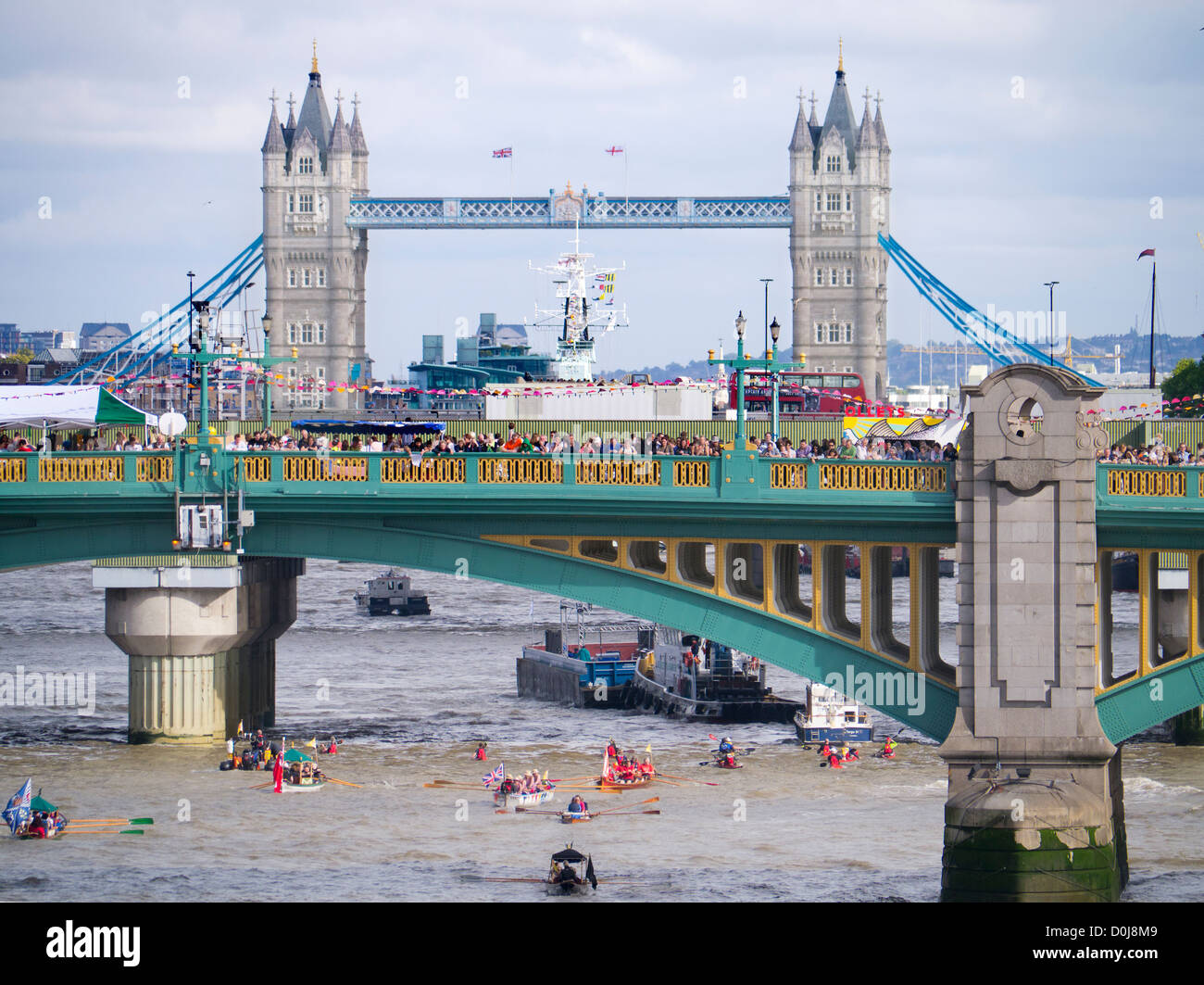 A flotilla of small boats passing under Southwark Bridge during the Thames Festival. Stock Photo