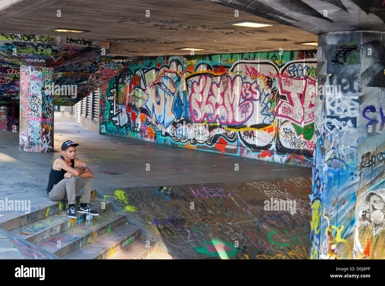 Resting cyclist at graffiti-land on the South Bank in London. Stock Photo