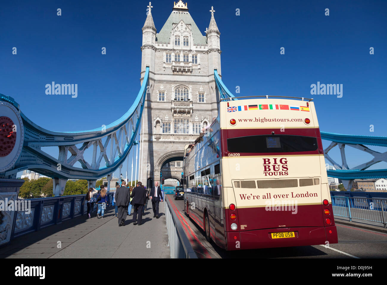 A tourist bus on Tower Bridge during an autumn heat wave. Stock Photo
