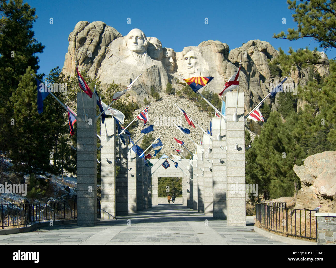 A man and woman stand alone viewing Mt. Rushmore National Monument at the park's Grand View Terrace. Stock Photo