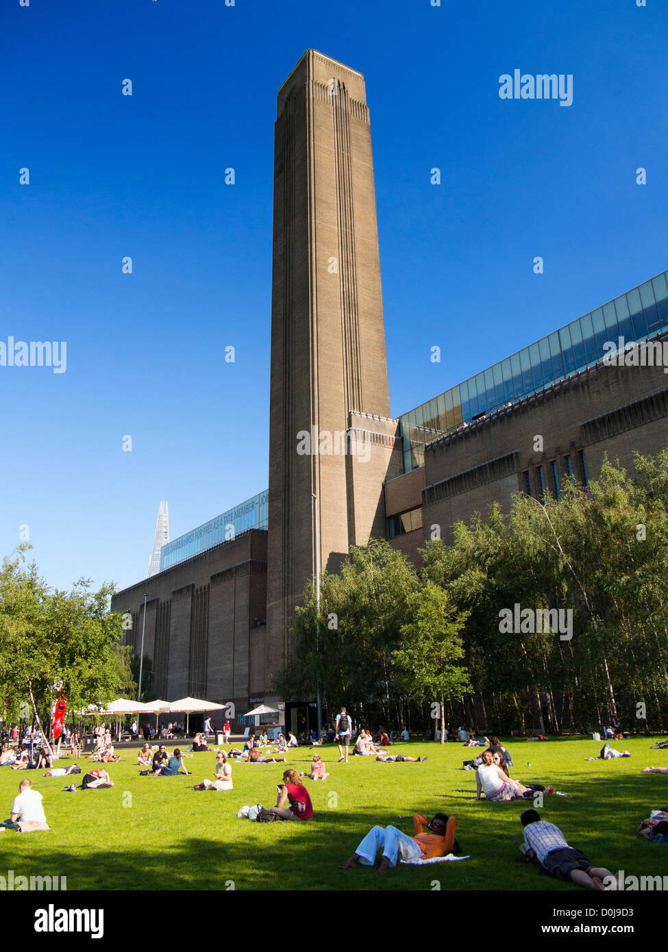 People enjoying a summer day in front of the Tate Modern gallery in London. Stock Photo