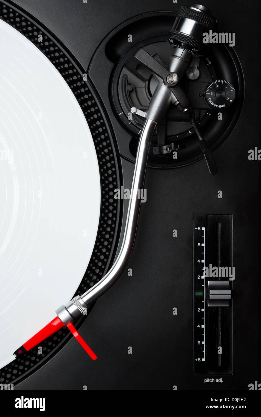 Professional DJ audio equipment - turntable needle on white vinyl record shot from above Stock Photo