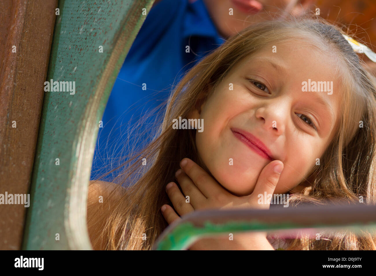 Cute little girl posing on the playgorund at bright summer day Stock ...