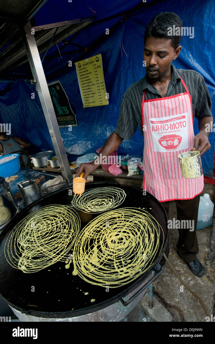 A man prepares Indian savoury snacks in Georgetown's Little India, Penang, Malaysia Stock Photo
