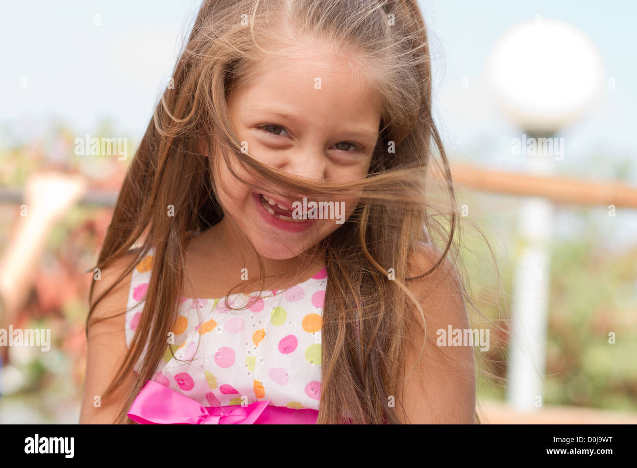 Cute little girl posing on the playgorund at bright summer day Stock ...