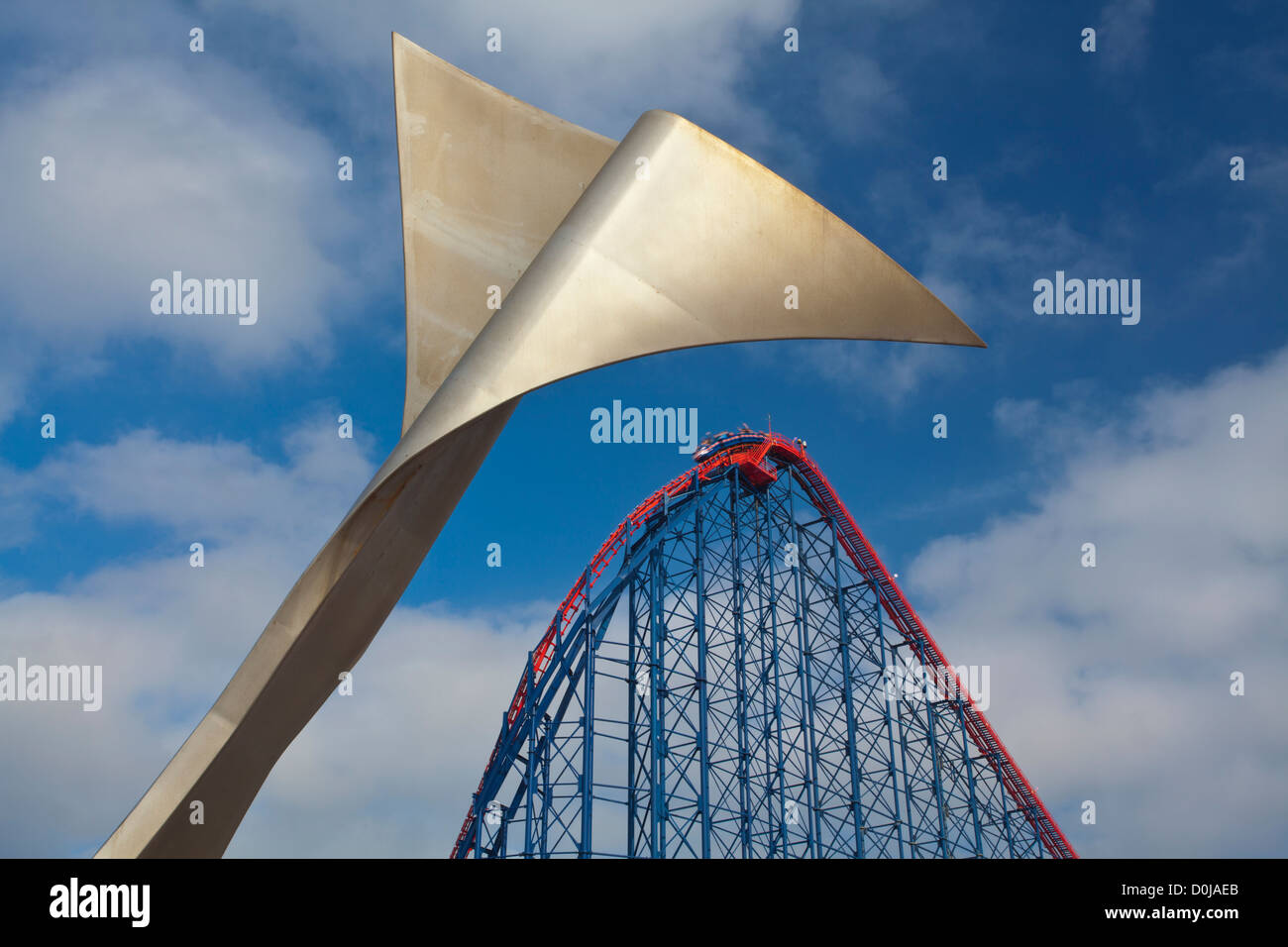 Whale tail sculpture with the Blackpool Pleasure Beach and the Big One in the distance. Stock Photo