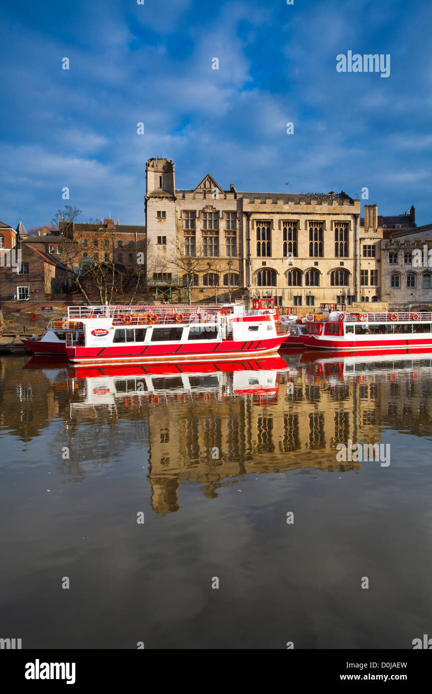 York city river cruise boats moored on the River Ouse with the Guildhall in the background. Stock Photo