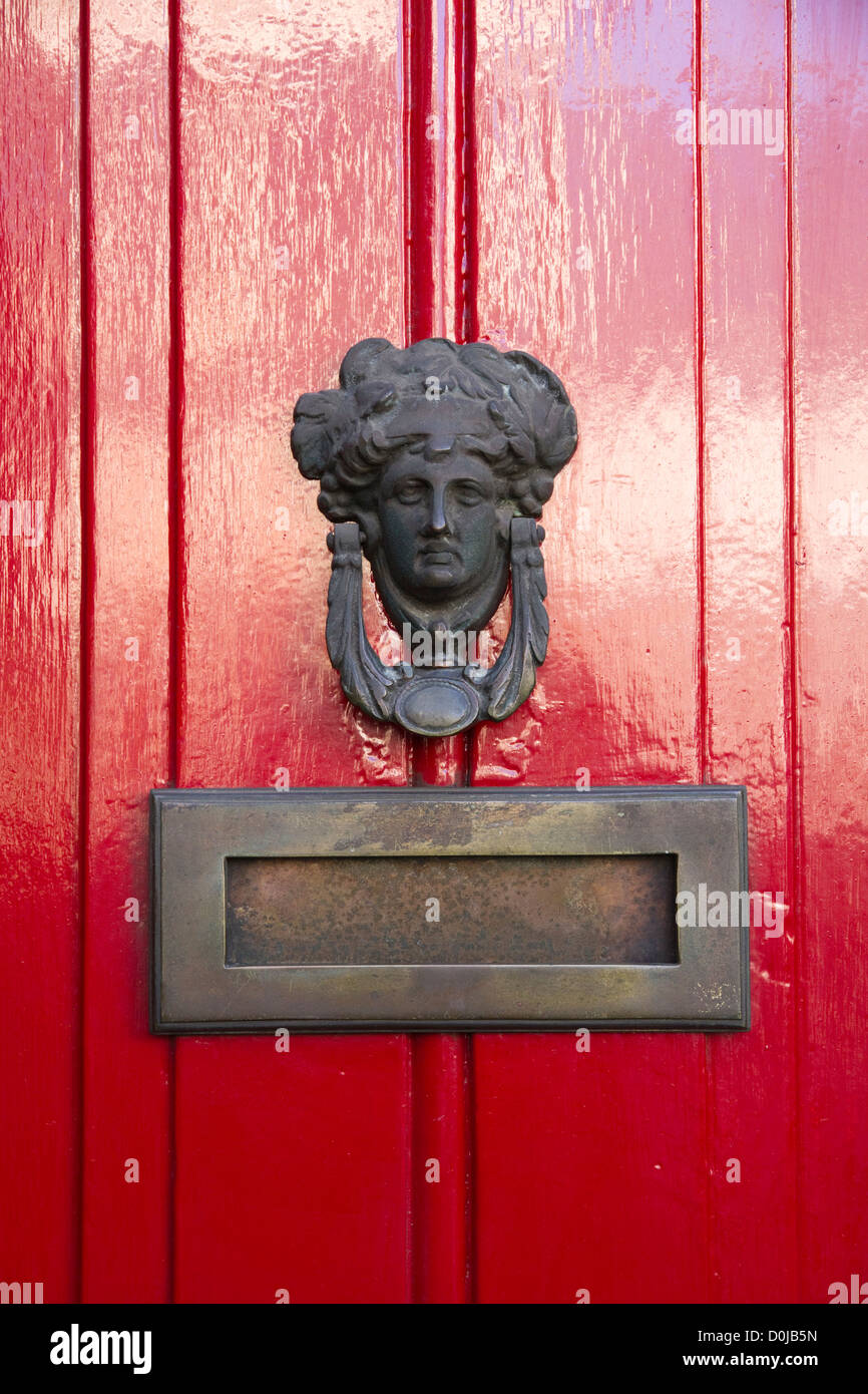 A traditional door knocker designed as a woman's head. Stock Photo