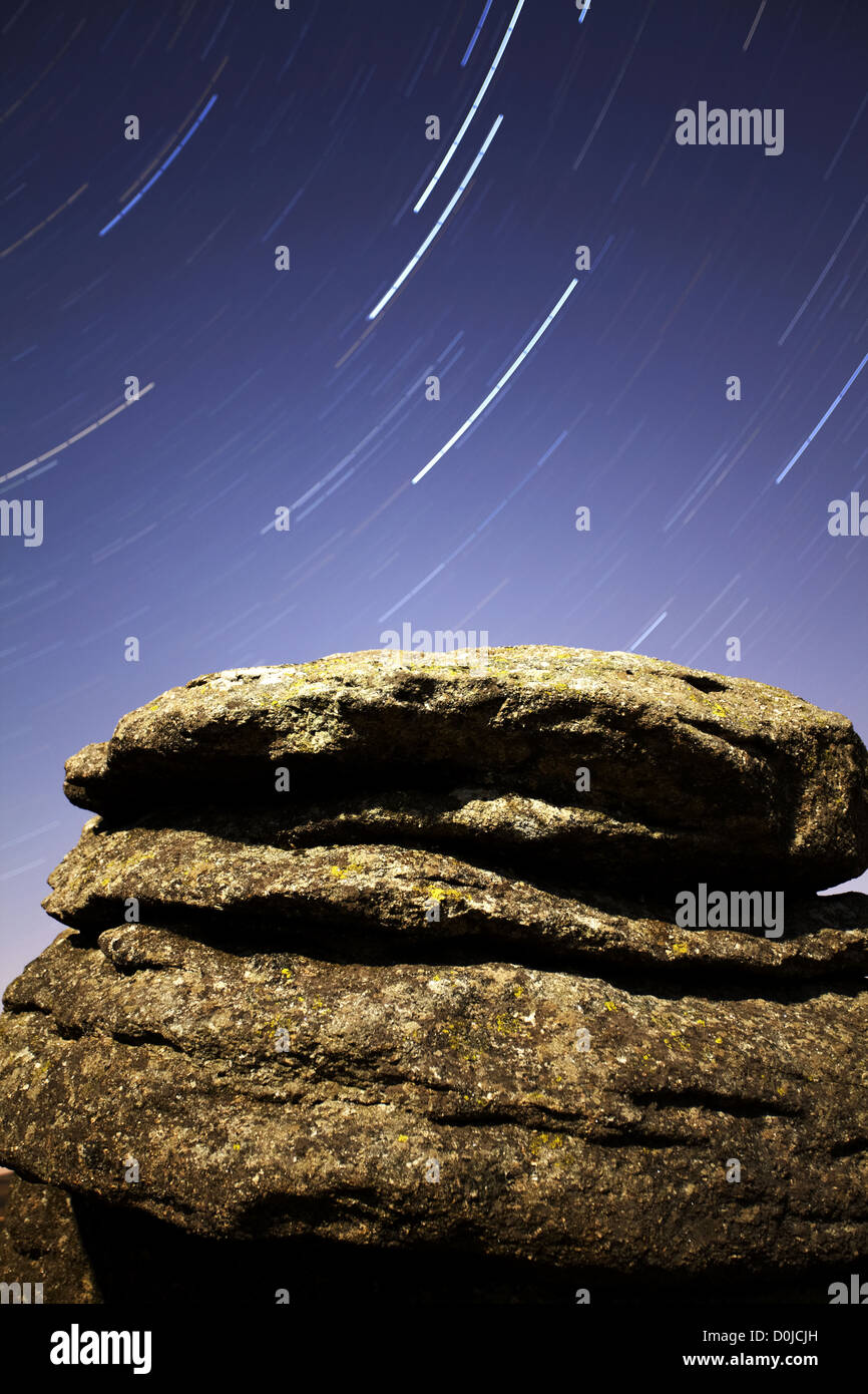 Polaris star trail over moonlit Combestone Tor on Dartmoor. Stock Photo