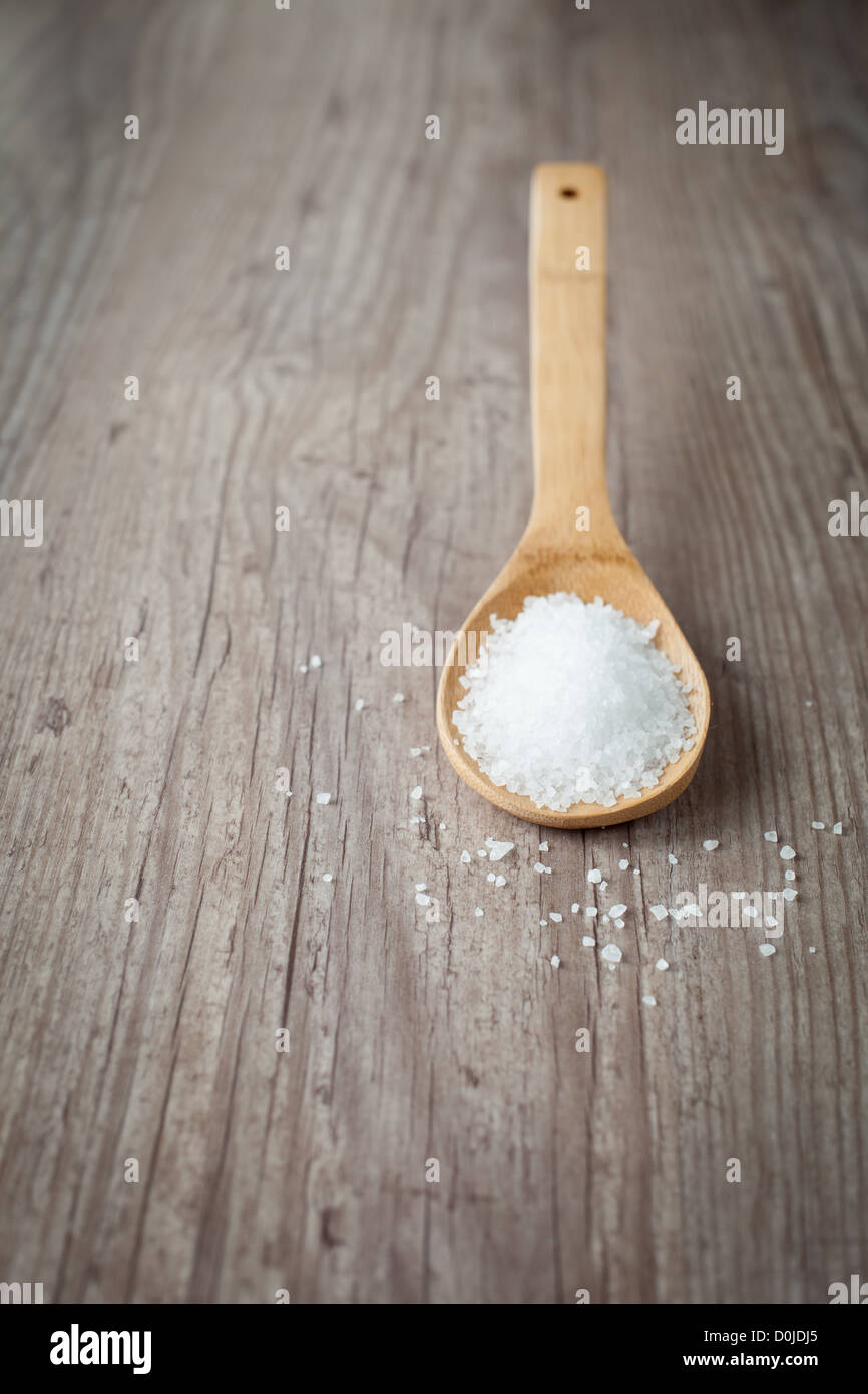 Bunch of sea salt on a wooden spoon Stock Photo