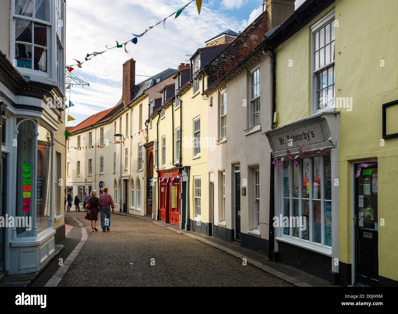 A couple stroll down one of the shopping streets in Cromer. Stock Photo