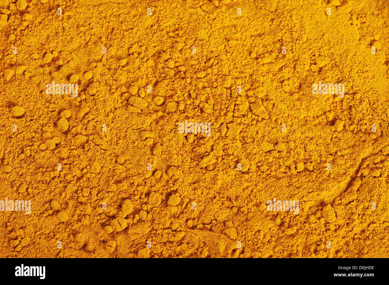turmeric powder background, yellow grain abstract texture Stock Photo