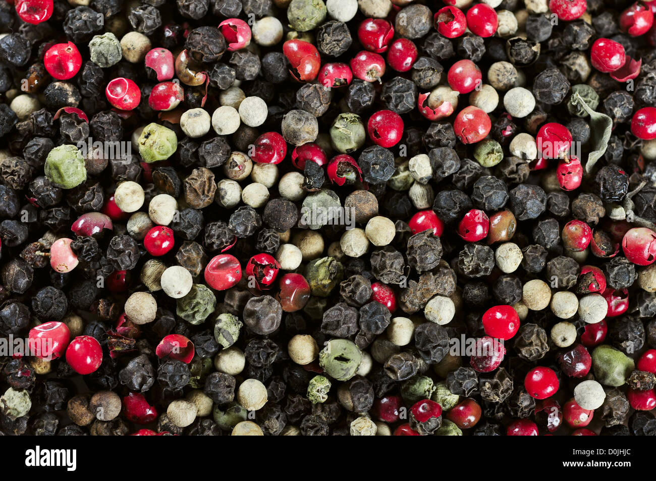 Mixed red, white and black peppercorns closeup. May used as background Stock Photo