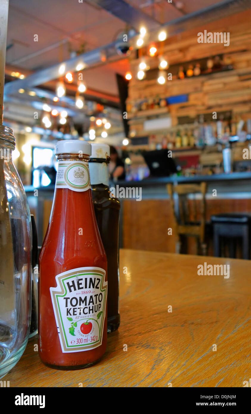 Tomato ketchup bottle on a pub table in East London. Stock Photo