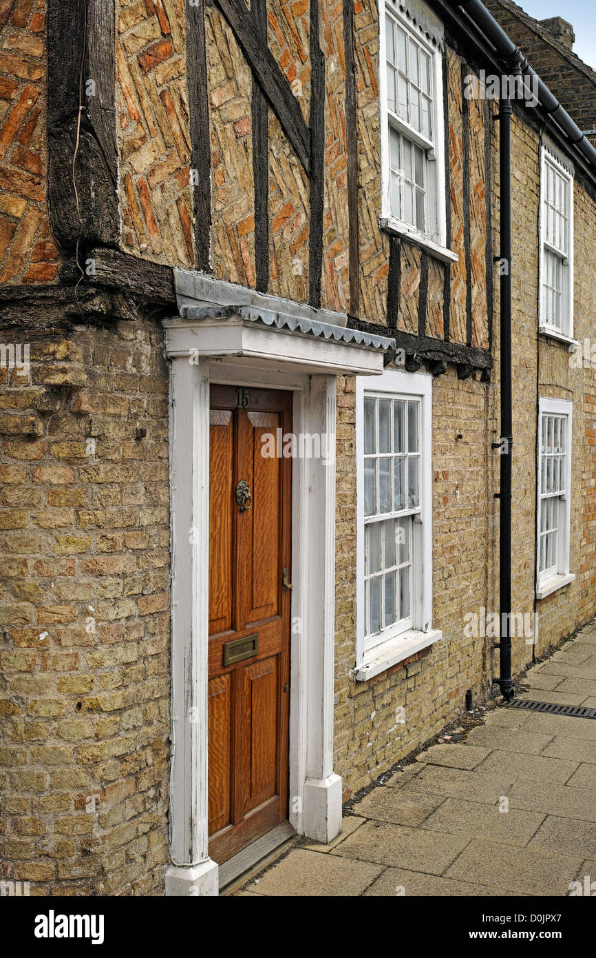 Old terraced house built of brick with timber frame in Waterside. Stock Photo