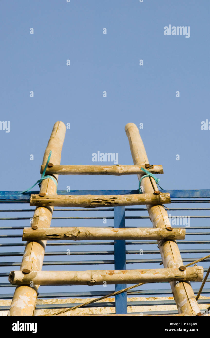 Low angle view of a ladder resting against the roof Stock Photo - Alamy