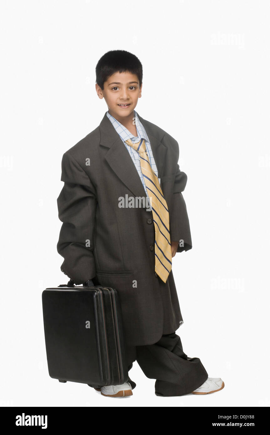 Portrait of a boy wearing oversized suit and holding briefcase Stock Photo
