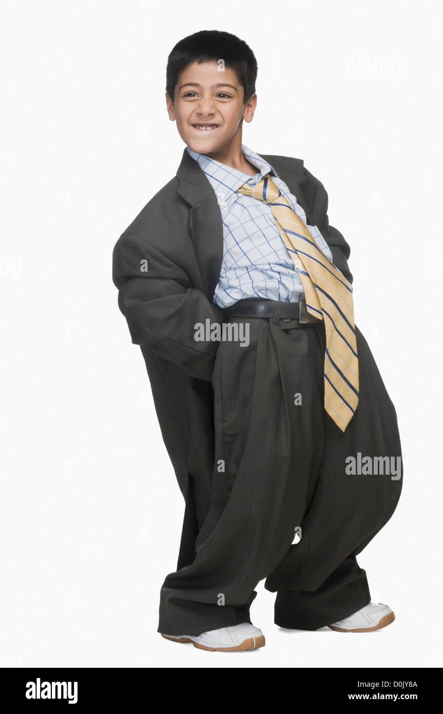 Boy wearing oversized suit and bending backward Stock Photo