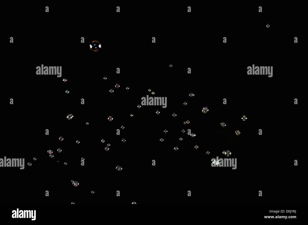 Soap bubbles against black background Stock Photo - Alamy